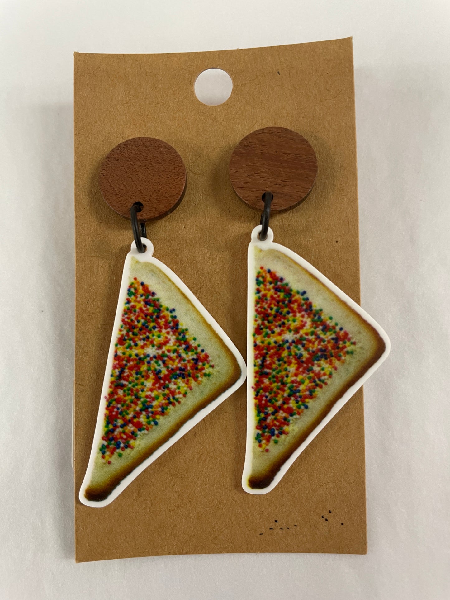 Vertical fairy bread 100s and 1000s resin dangle earrings featuring one piece of fairy bread on each earring with natural timber stud tops by Beldari Pottery.