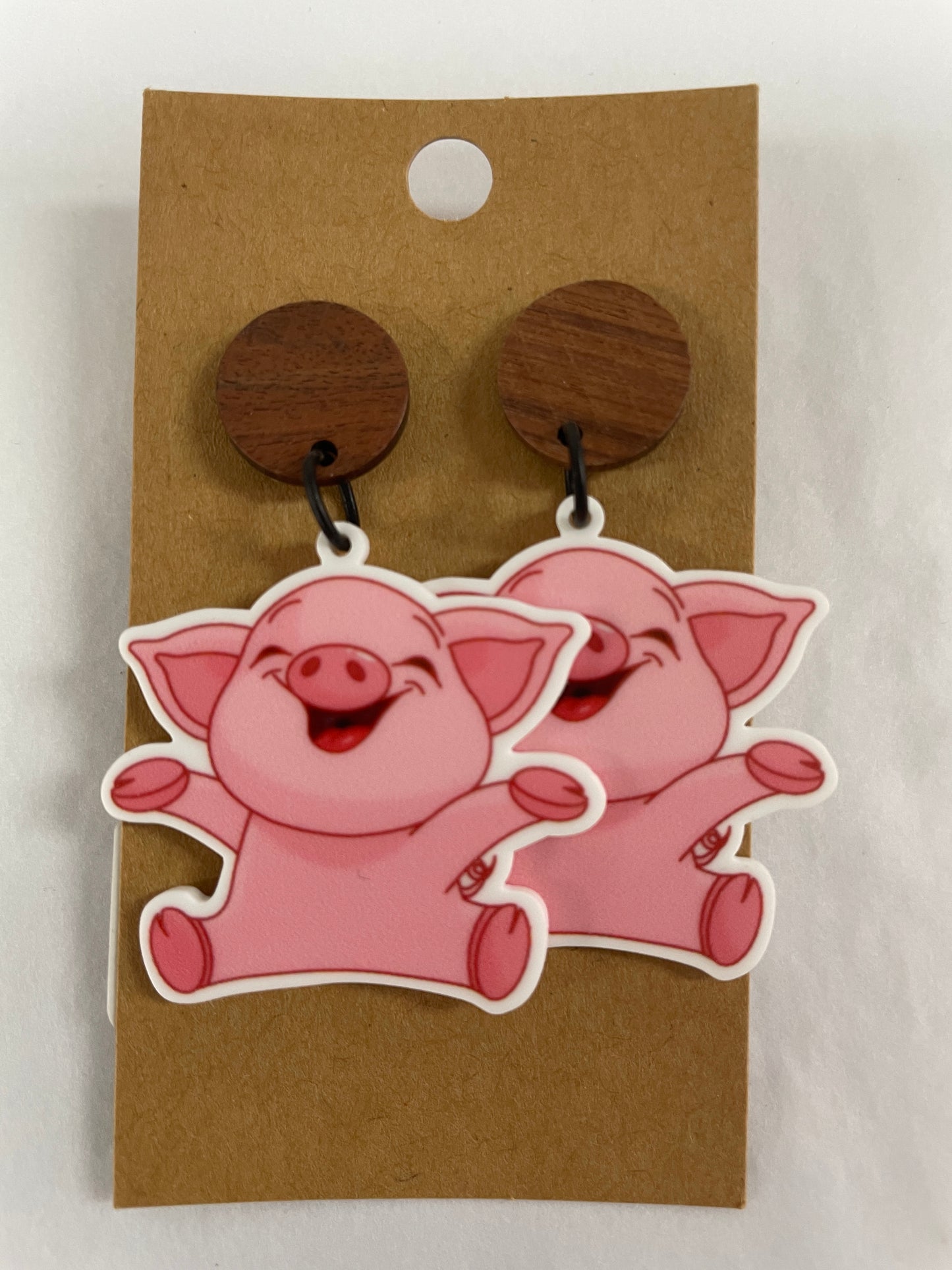 Happy pig resin dangle earrings featuring one cute pig on each earring with natural timber stud tops by Beldari Pottery.
