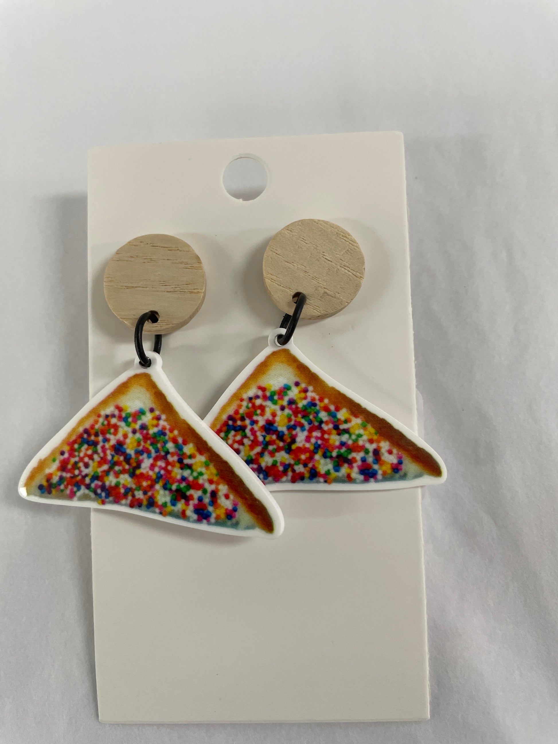 Horizontal fairy bread 100s and 1000s resin dangle earrings featuring one piece of fairy bread on each earring with natural timber stud tops by Beldari Pottery.