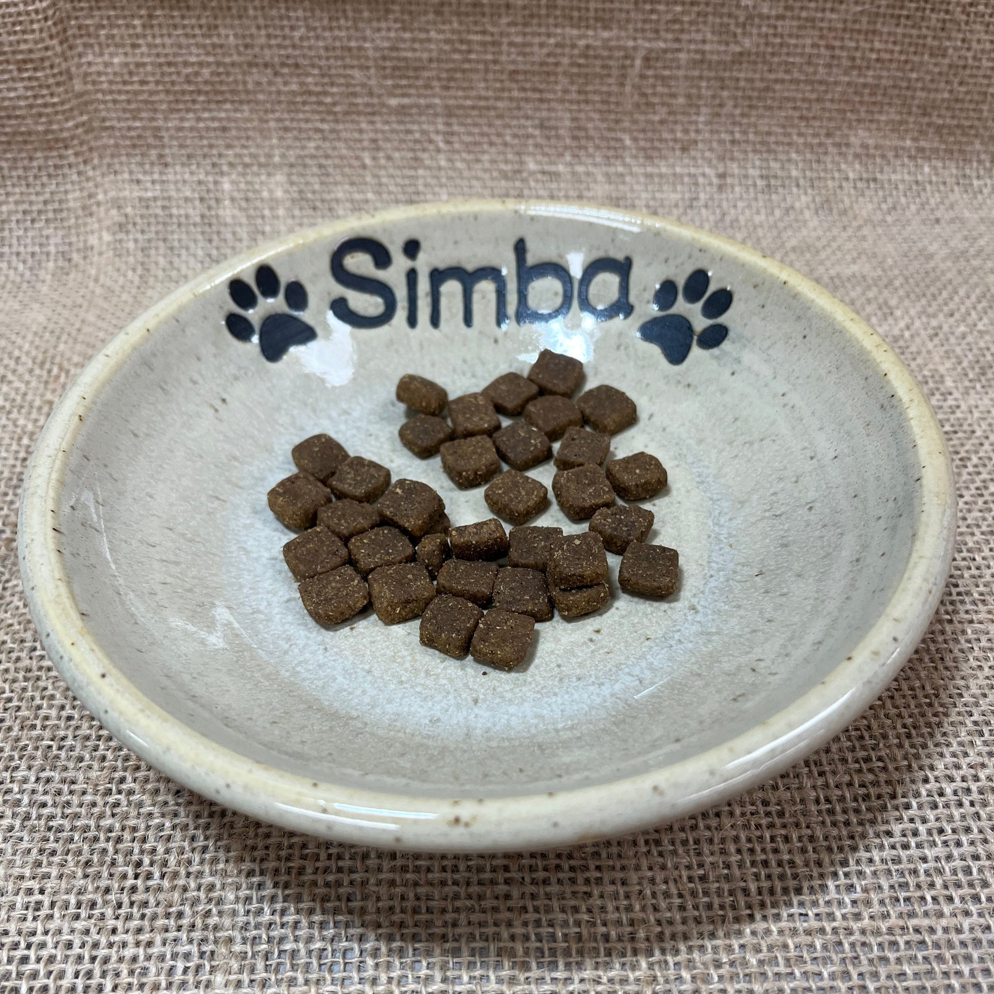 Pet food in a bowl with 'Simba' branding on a textured surface