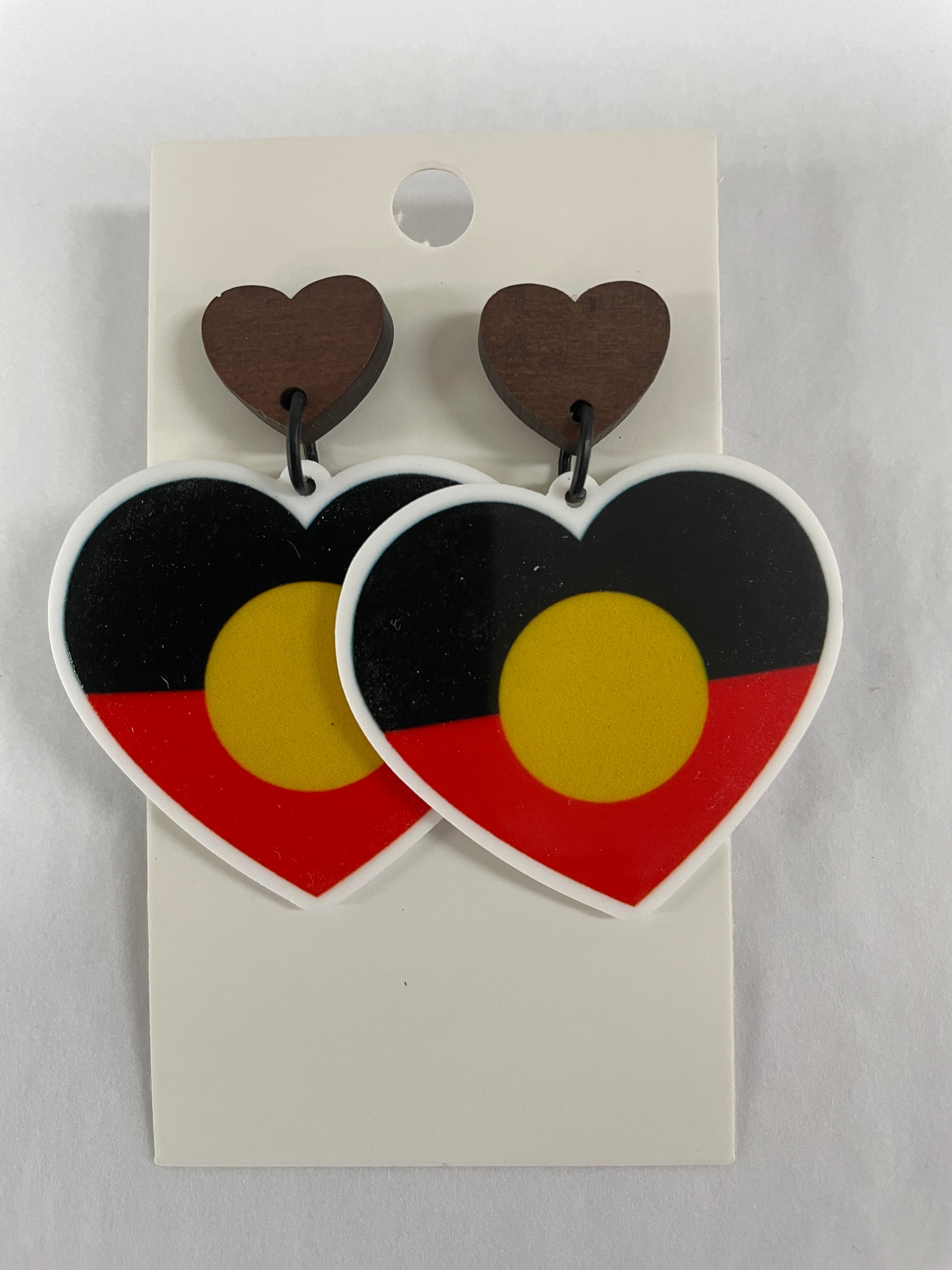 Flag heart-shaped resin dangle earrings with natural timber stud tops by Beldari Pottery.