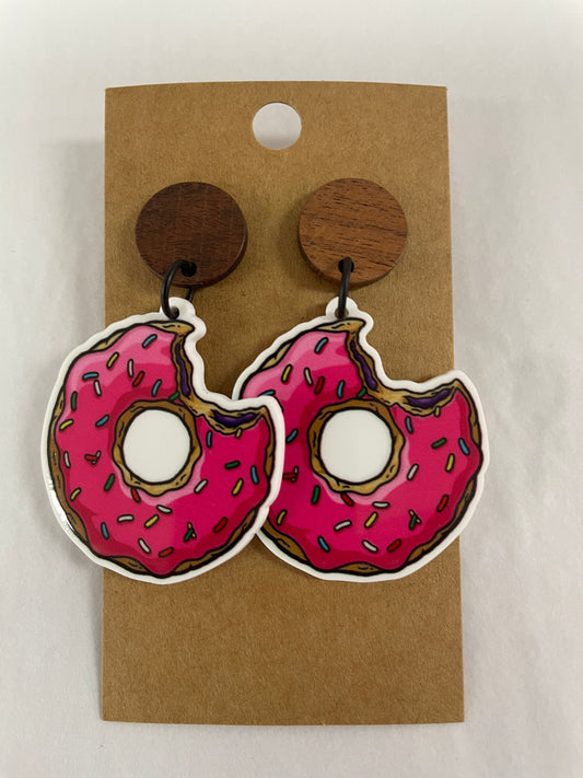 Pink iced donut resin dangle earrings with a bite taken out and natural timber stud tops by Beldari Pottery.