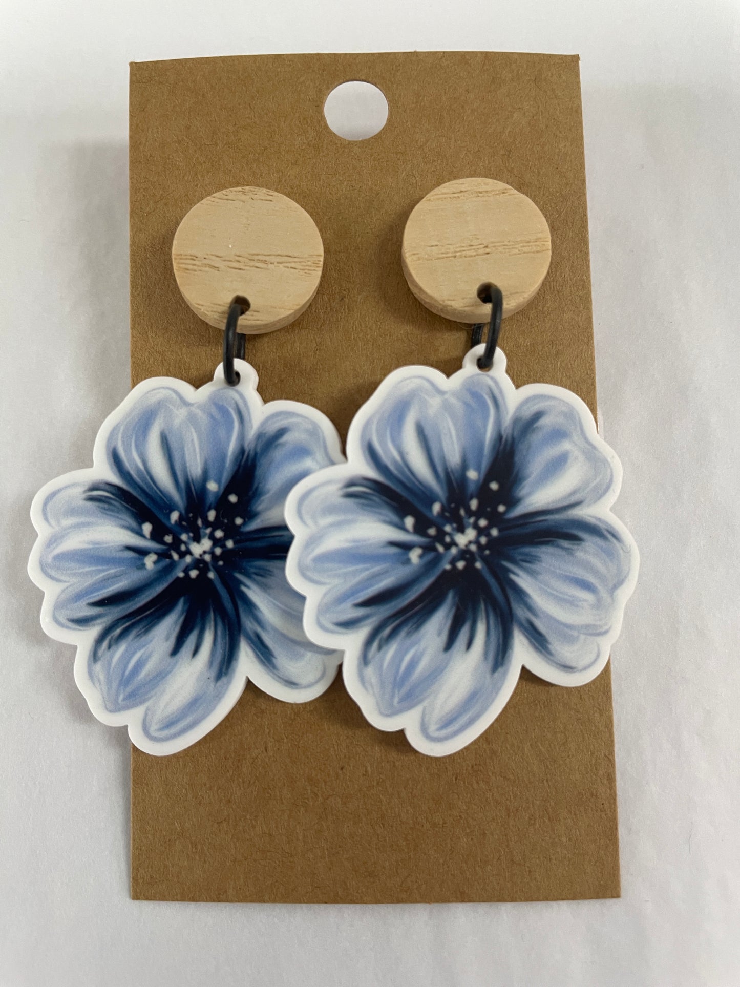 Blue hibiscus flower resin dangle earrings with one large flower on each earring and natural timber stud tops by Beldari Pottery.