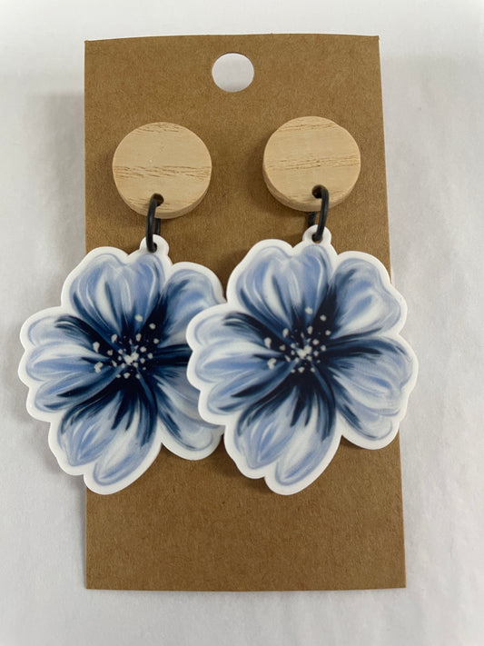 Blue hibiscus flower resin dangle earrings with one large flower on each earring and natural timber stud tops by Beldari Pottery.