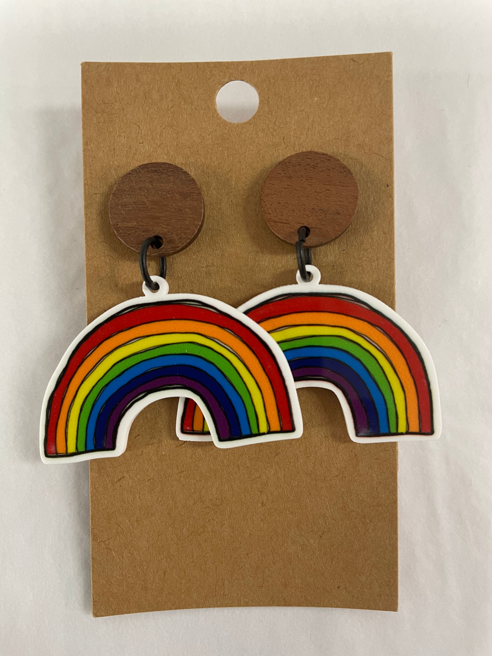 Colourful rainbow resin dangle earrings featuring one rainbow on each earring with natural timber stud tops by Beldari Pottery.