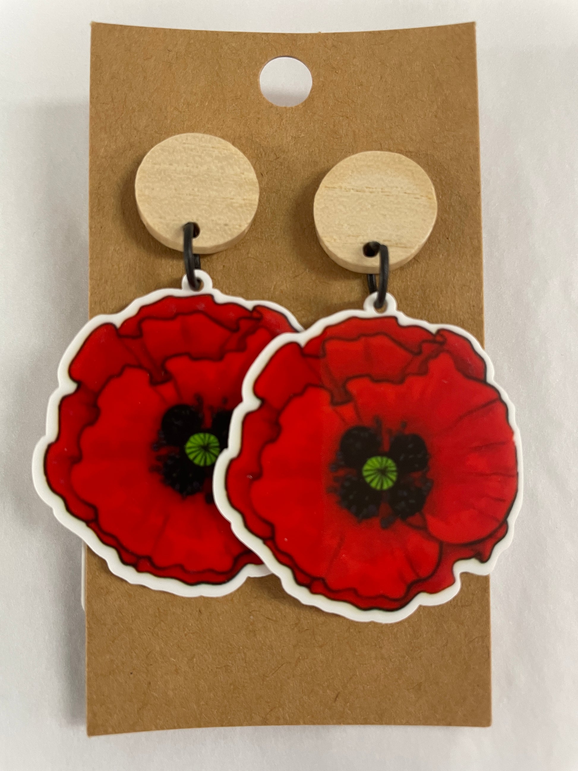 Red poppy resin dangle earrings featuring one red poppy on each earring with natural timber stud tops by Beldari Pottery.