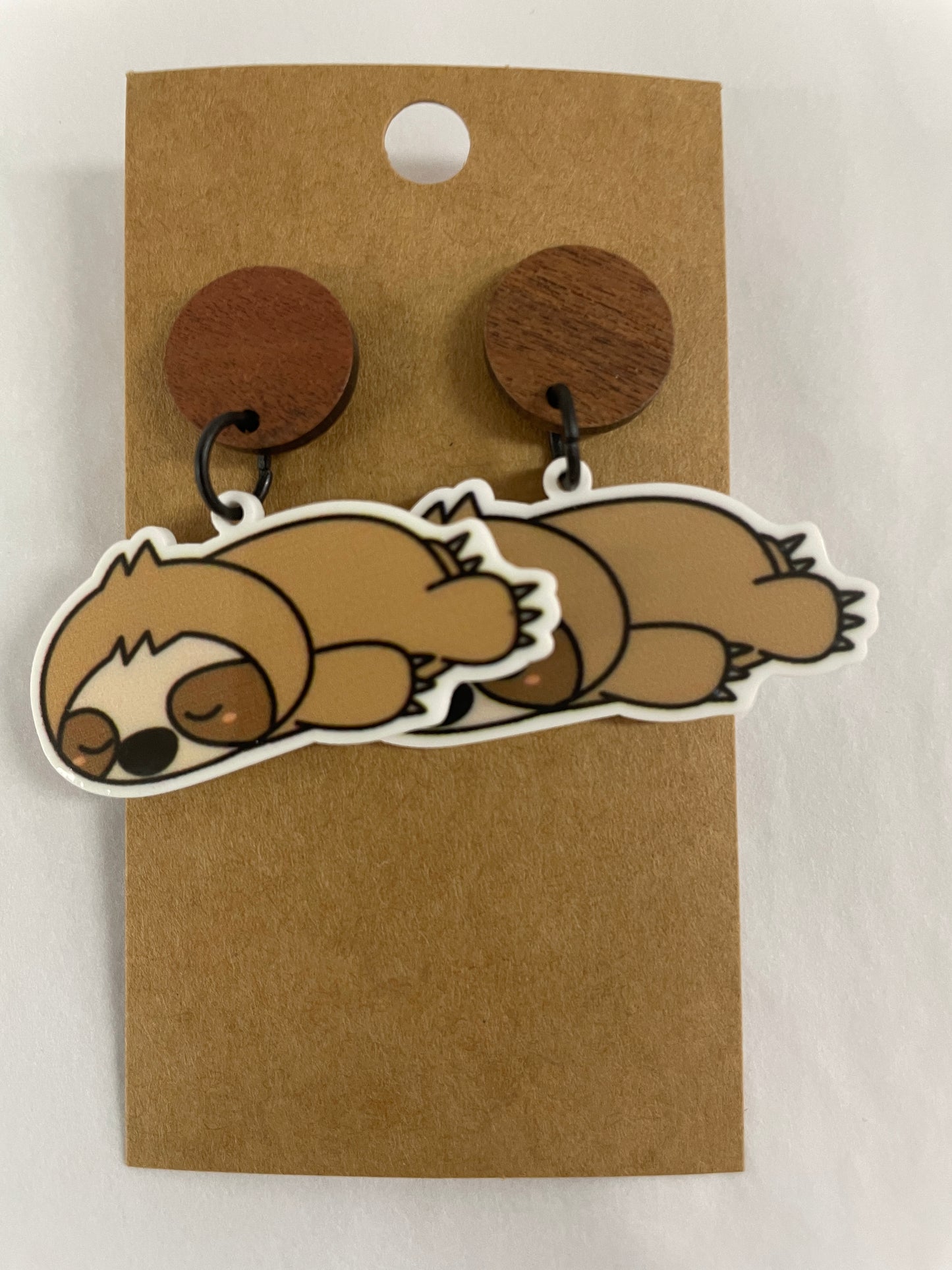 Sleeping sloth resin dangle earrings featuring one cute sloth on each earring with natural timber stud tops by Beldari Pottery.