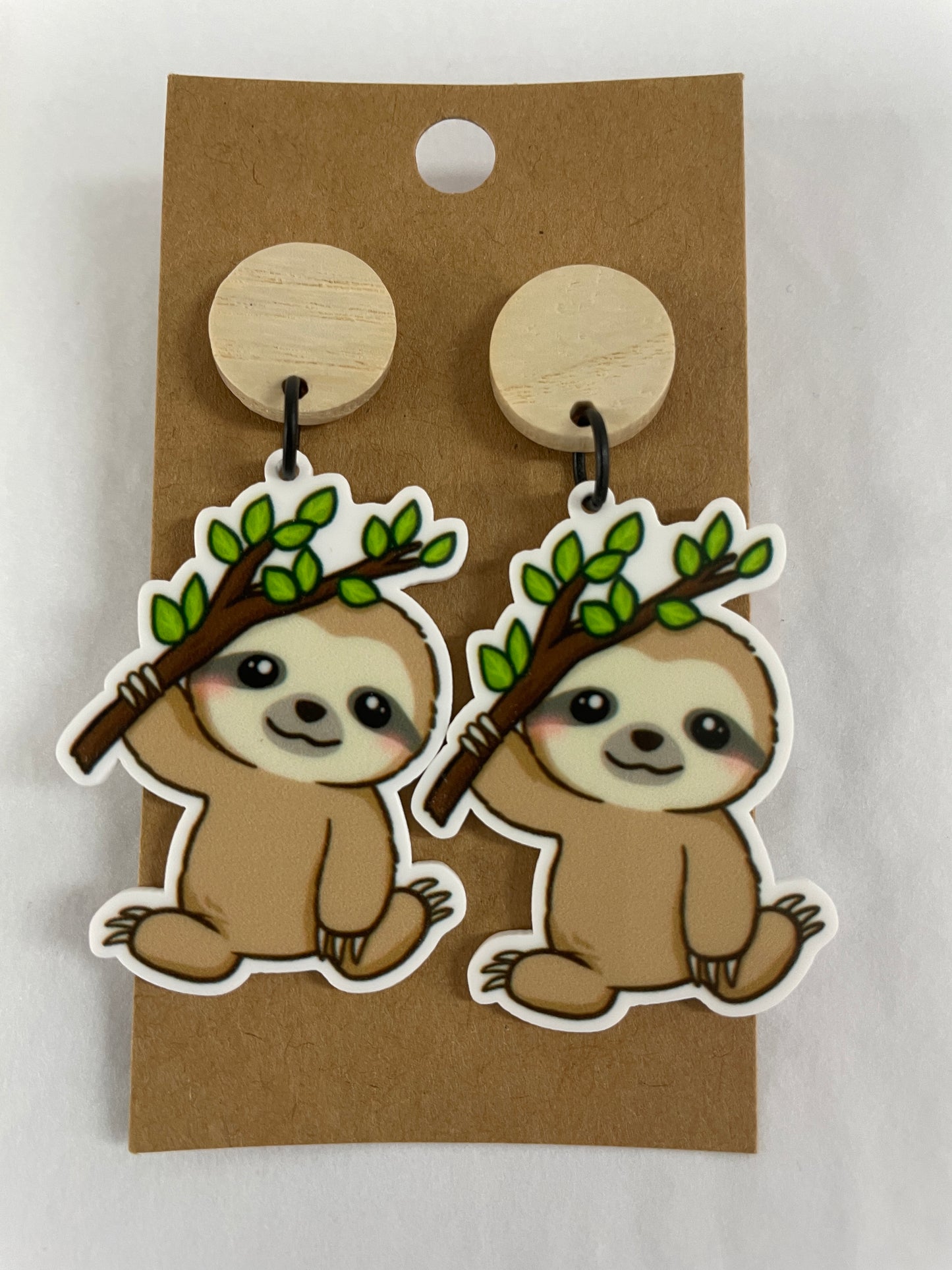 Cute sloth resin dangle earrings featuring one sloth hanging from a branch on each earring with natural timber stud tops by Beldari Pottery.