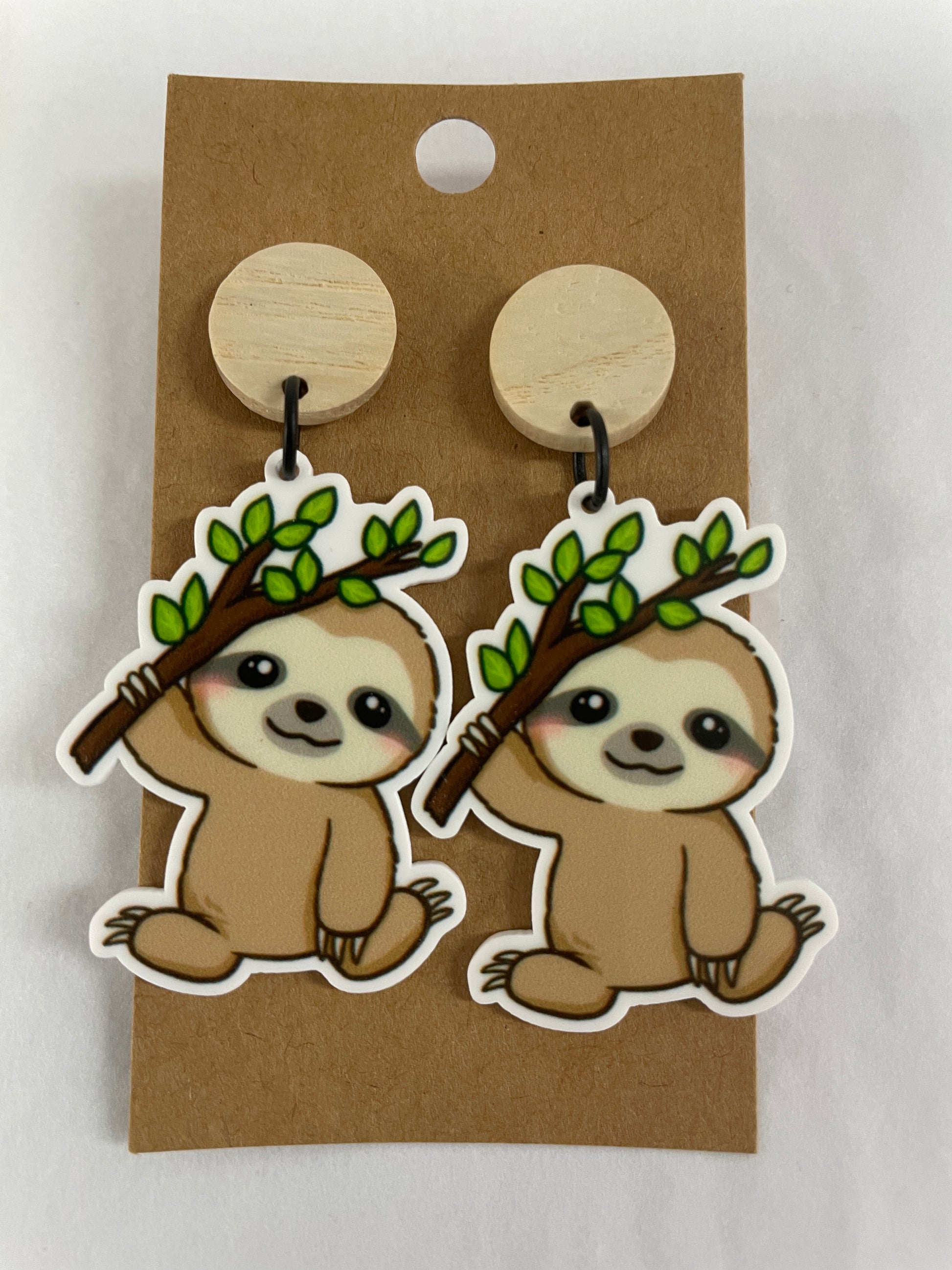 Cute sloth resin dangle earrings featuring one sloth hanging from a branch on each earring with natural timber stud tops by Beldari Pottery.
